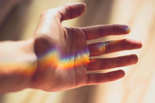 hand with rainbow reflection