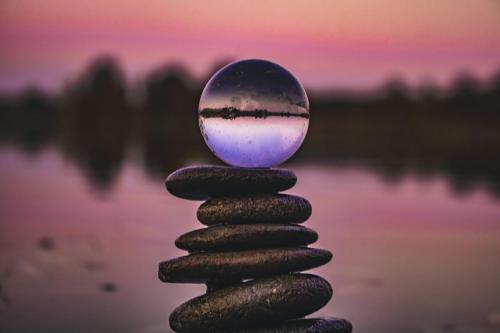 sphere on rocks pink sunset