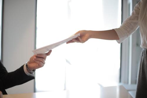 two people exchanging paper